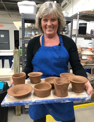 Teaching Center student with her own leather hard pieces, beginning wheel class