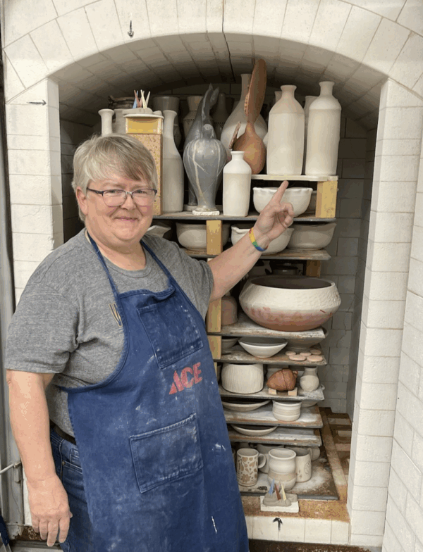 Julia Mann in front of loaded gas kiln