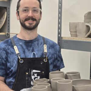 Jack Henry Ceramic Artist and Instructor with multiple pots close up