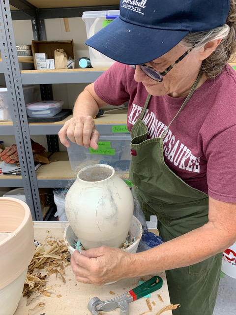 Ceramic artist/instructor working on a saggar pot