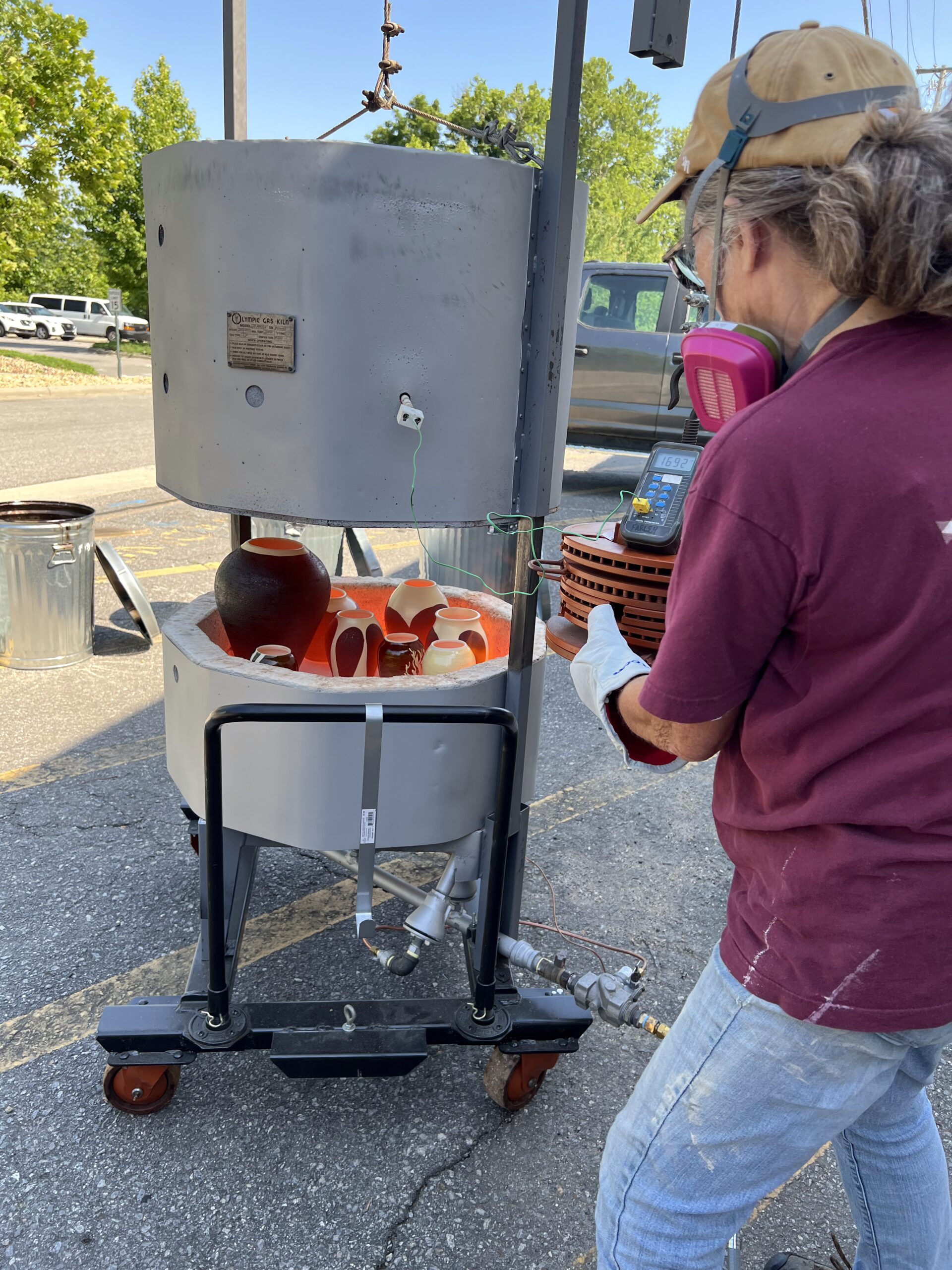 Judi Pulling Pots from Raku Kiln